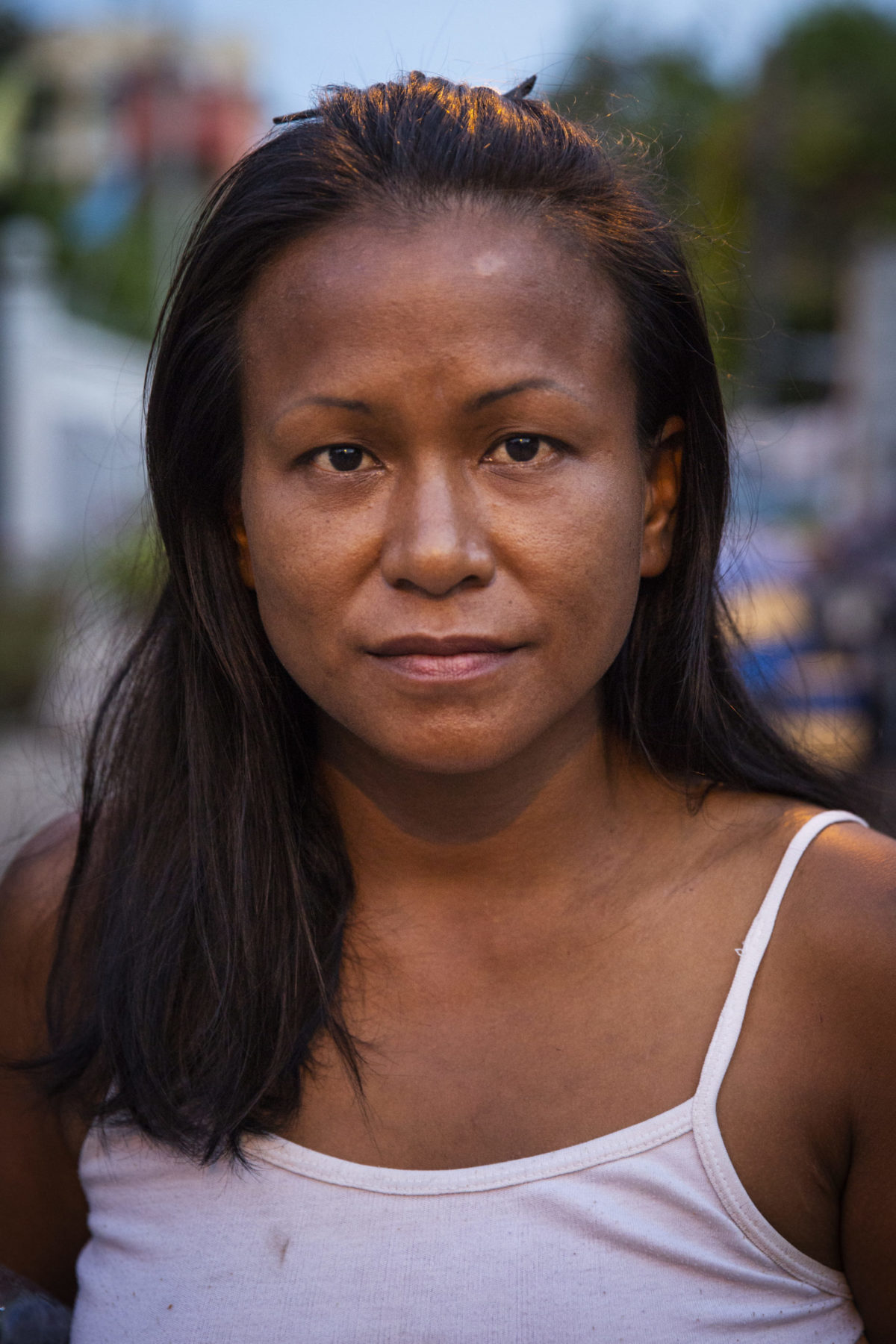 A young person in a white tank top. 