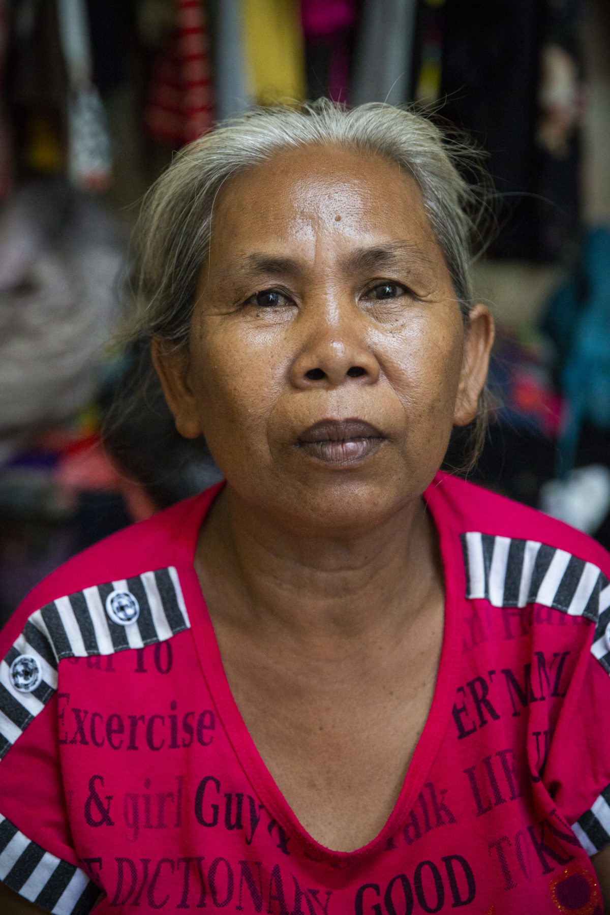 An elderly person wearing pink. 