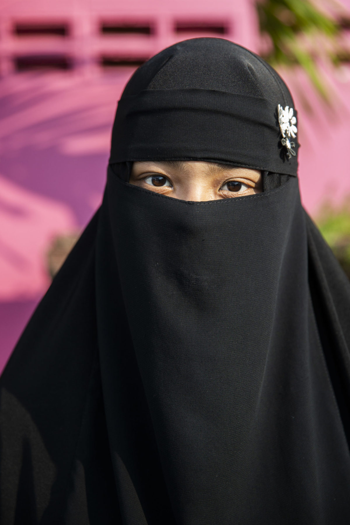 A person wearing a black burka.