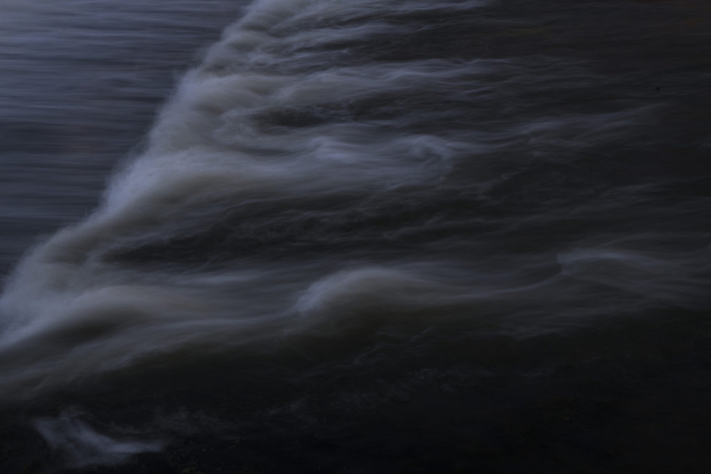 Water in motion is pictured in a blurred photograph. 
