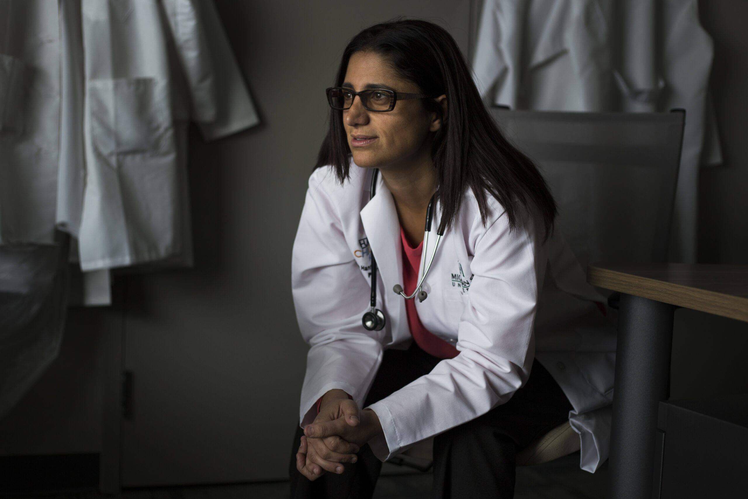 Medium shot of Dr. Mona Hana Attisha sitting looking off-camera