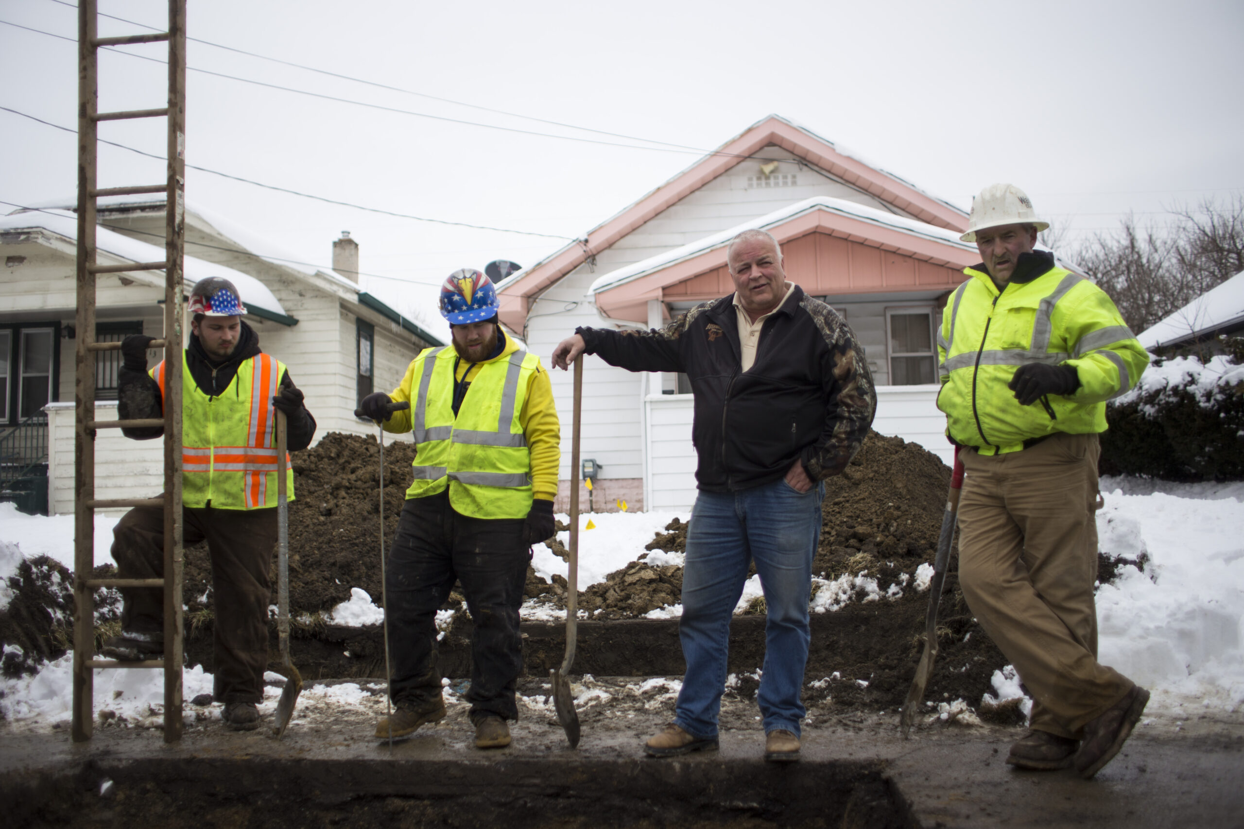 Group of four construction workers standing in the streets