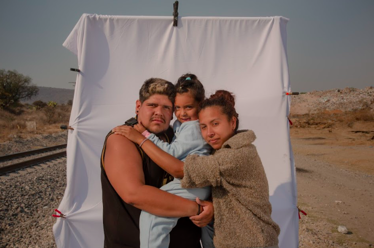 Eugenio, Alejandra, and their daughter Emily pose for a picture close to the area known as "The Dump" in the outskirts of Huehuetoca, Mexico. Photo by Oscar B. Castillo and Wil Sands.